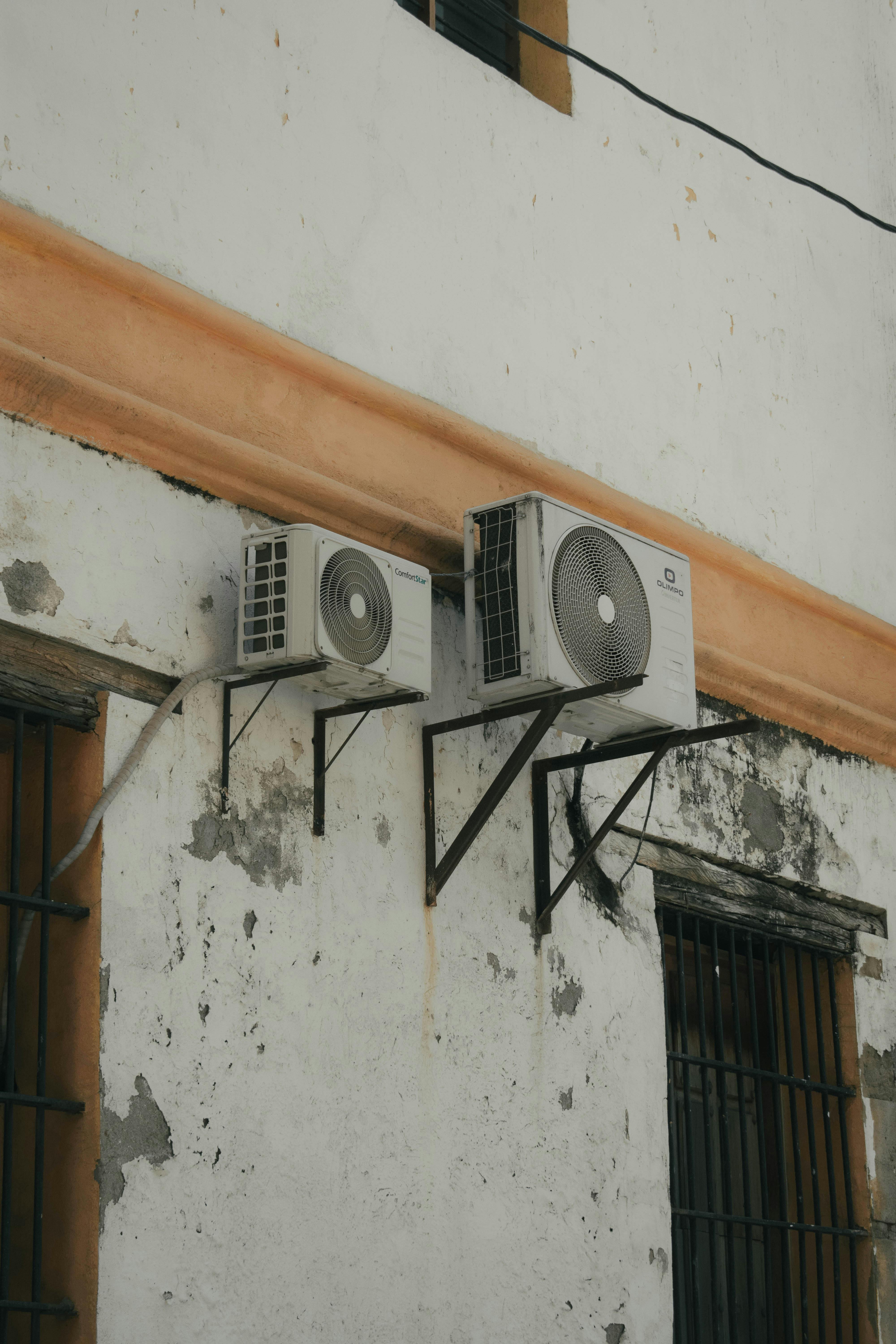 Twin air conditioning units fitted neatly on an outside wall